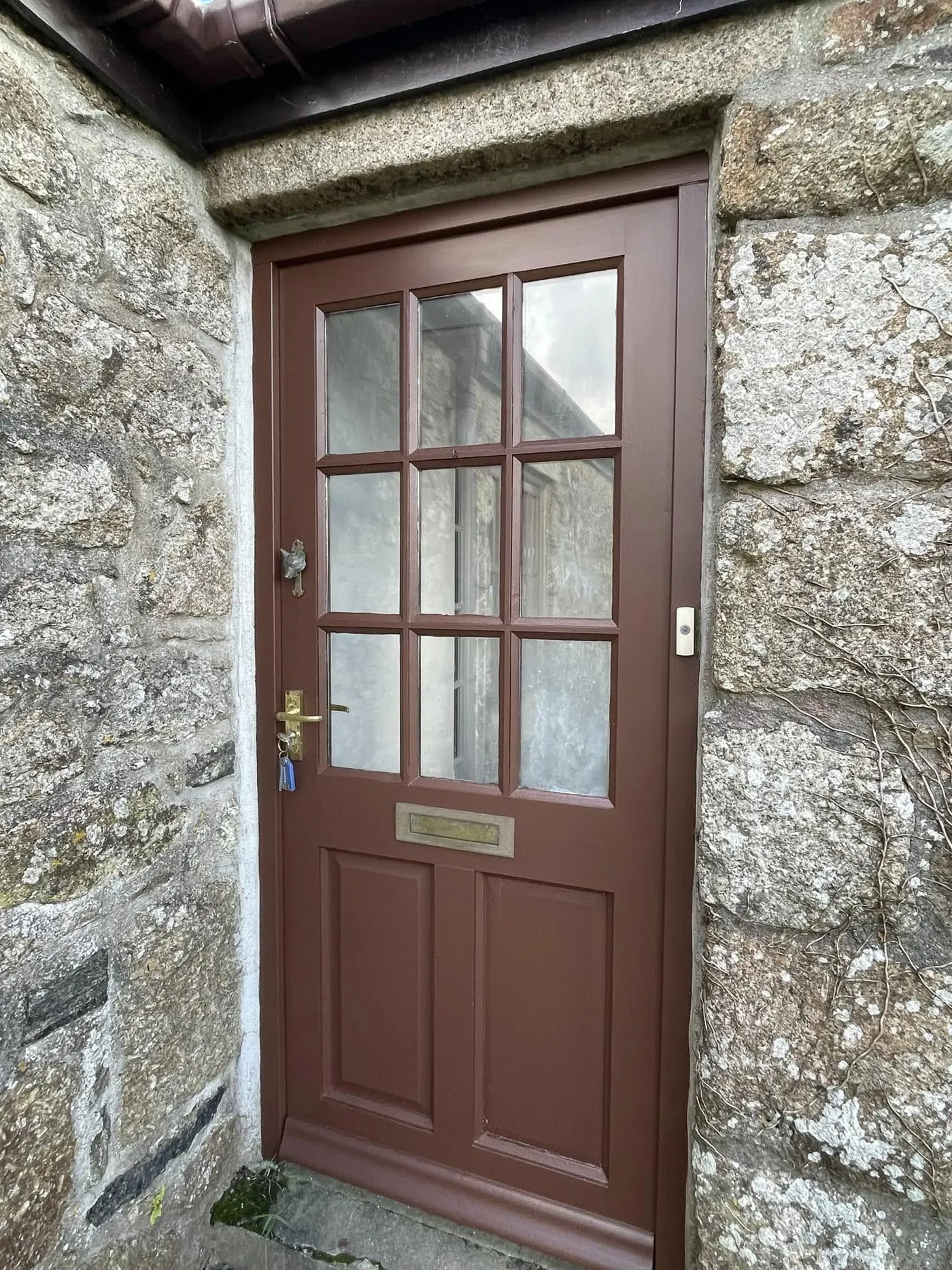 Glazed timber front door in a granite surround
