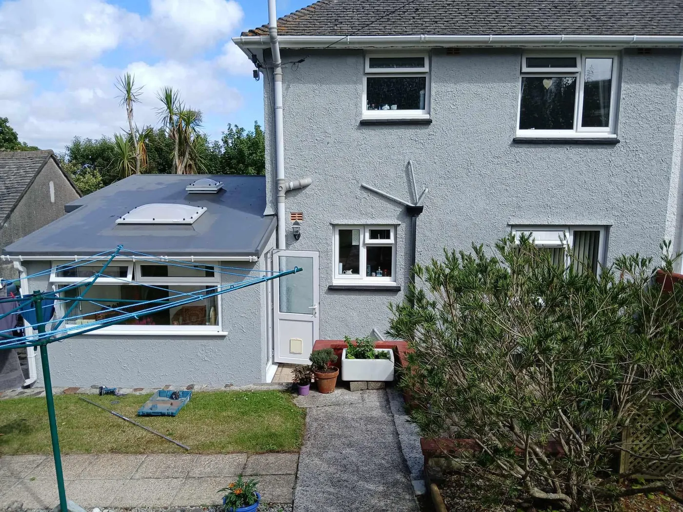 Grey render and white windows from the garden