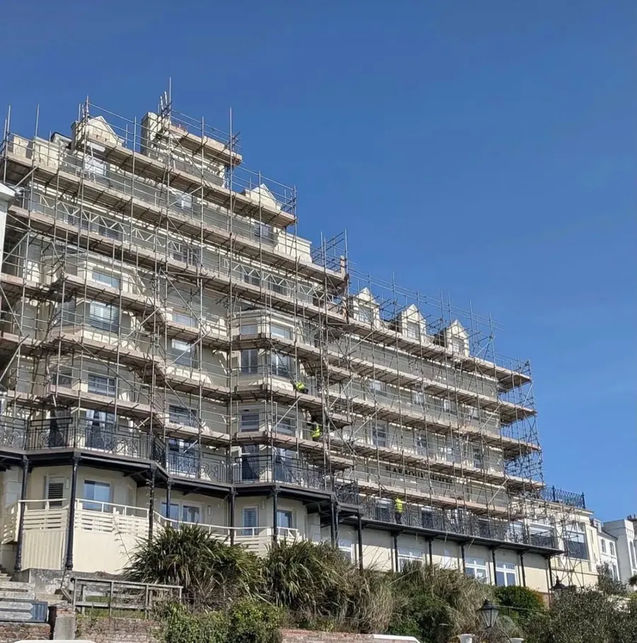 Large hotel exterior under full scaffold