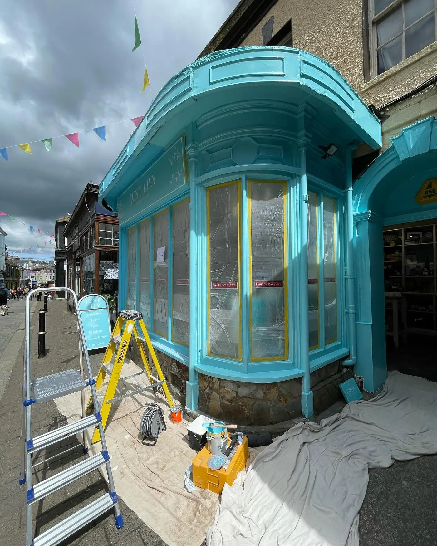 Turquoise shop front being prepared