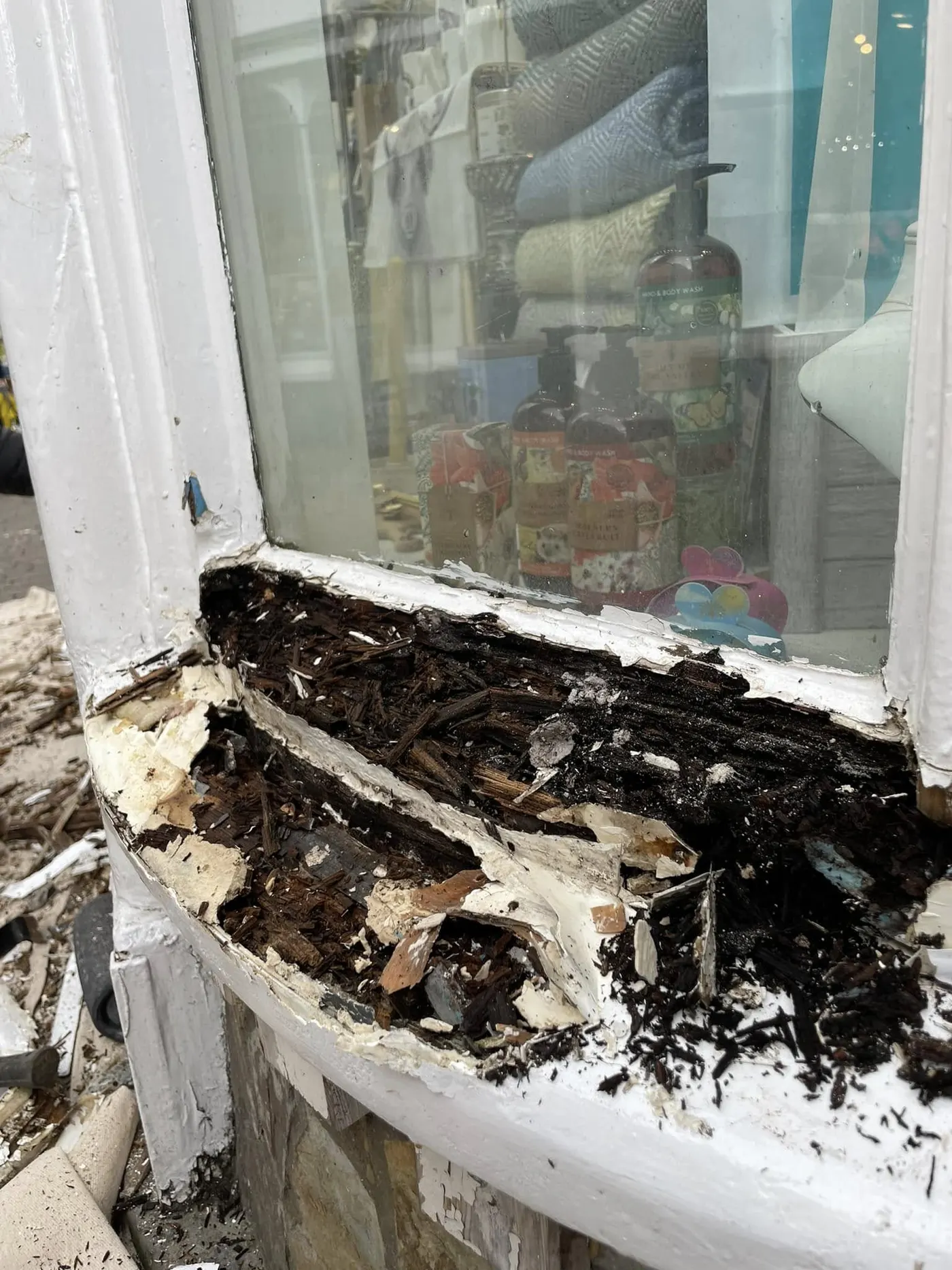 Rotten shop window base opened up for repair