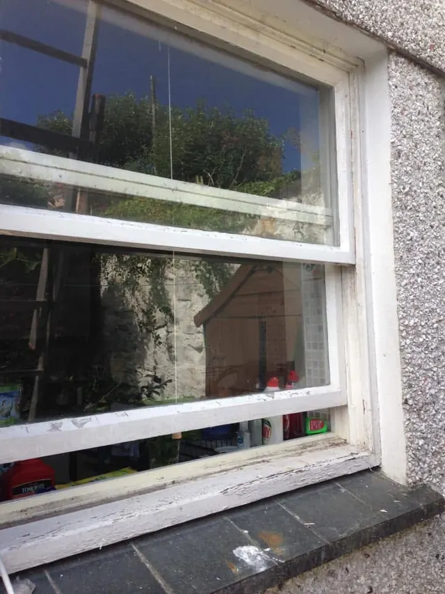 Sash window in pebbledash