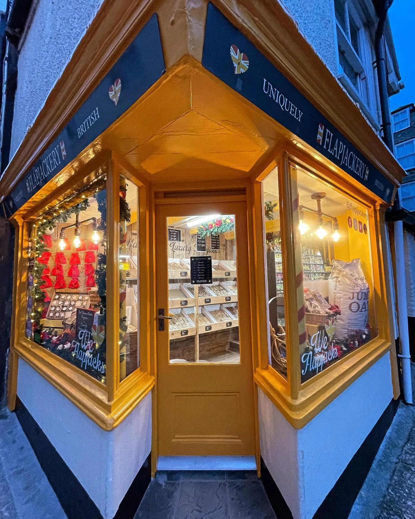 Corner shop front lit up after restoration