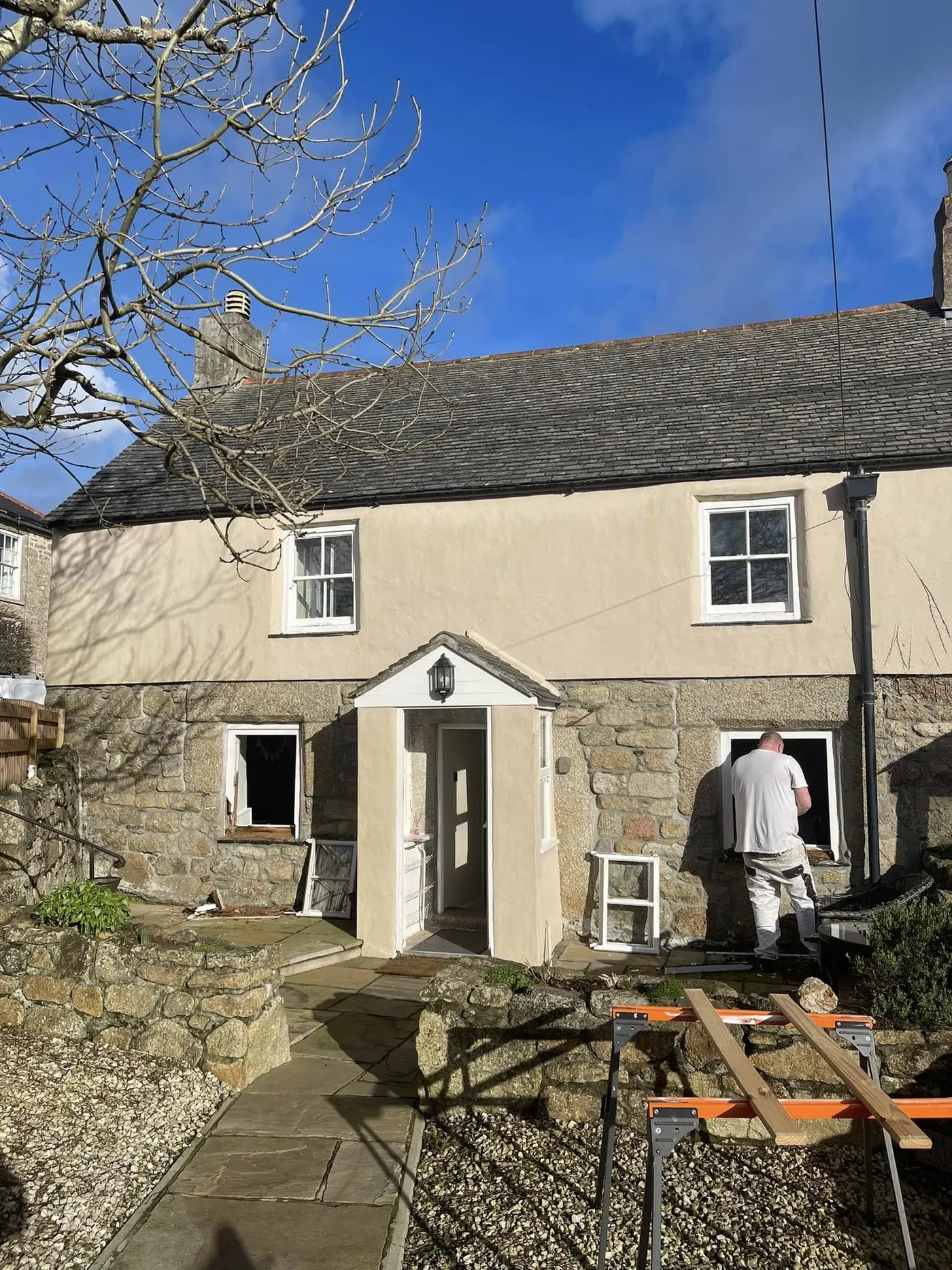 Granite cottage with scaffold tower and new timber