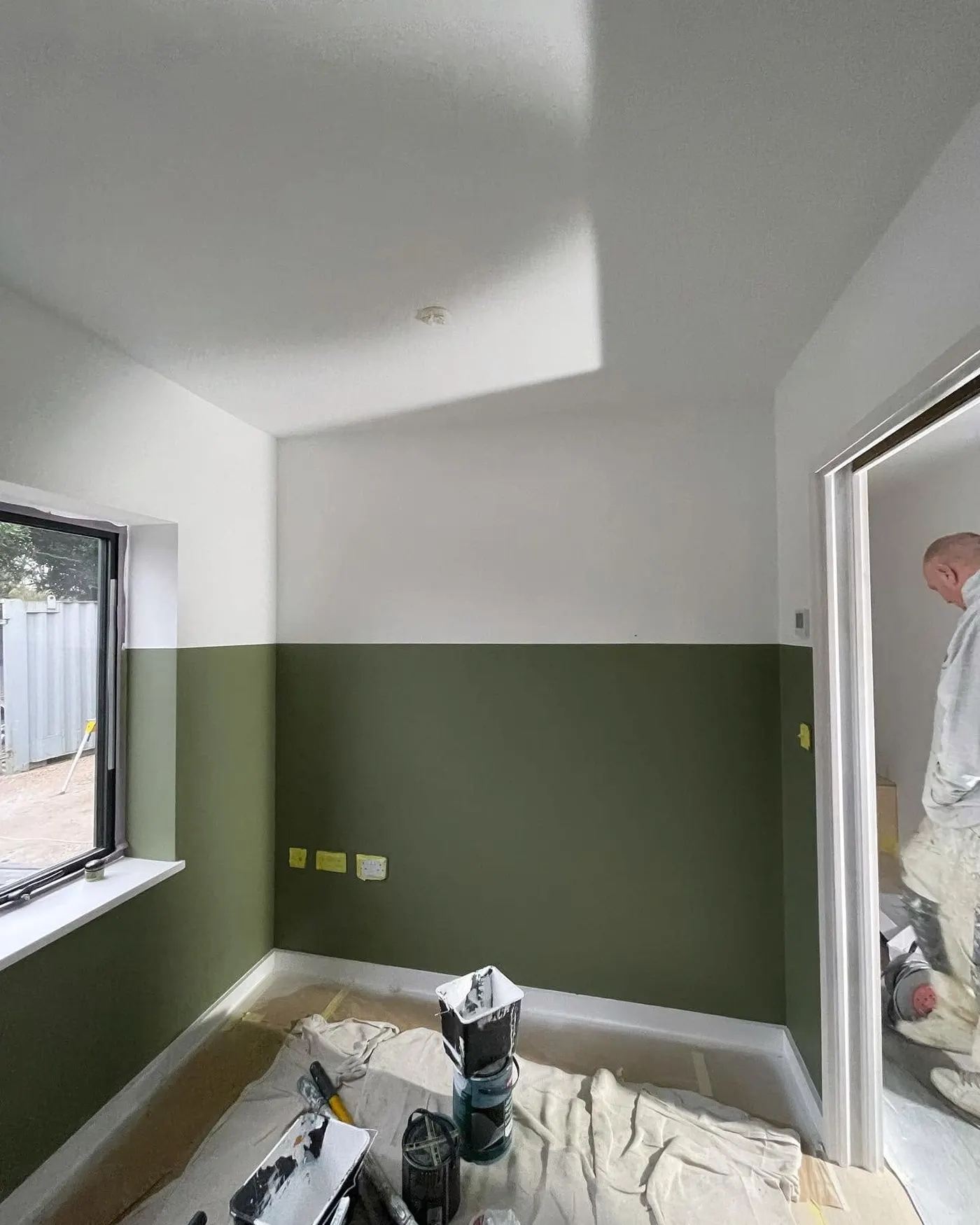 Green lower walls and white upper walls in a bedroom